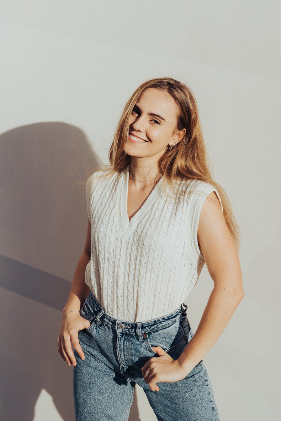 Woman in White Top and Blue Denim Jeans